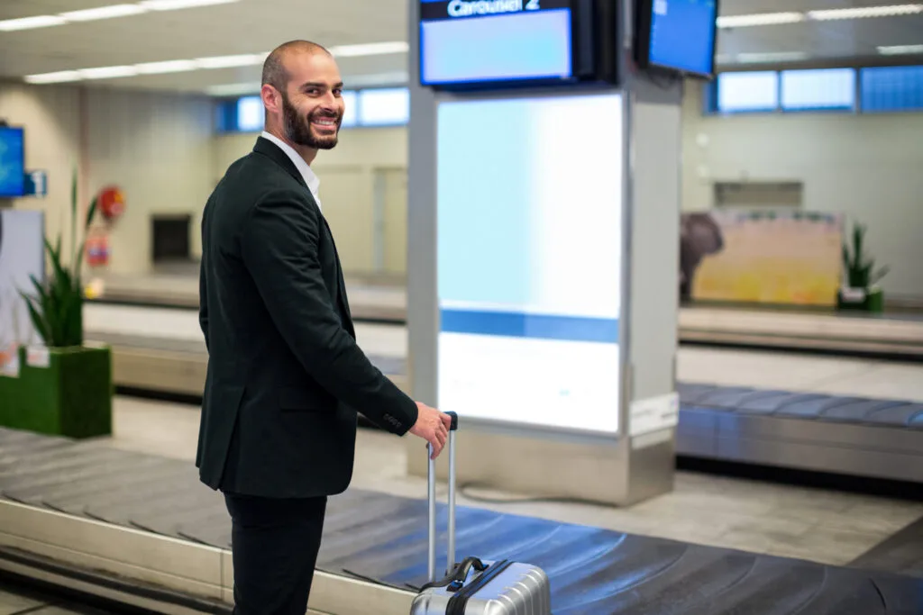 Businessman-standing-with-luggage-bag-in-airport