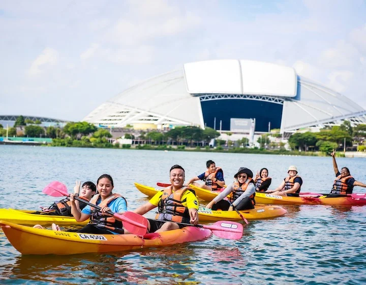 Guests enjoying a day of kayaking in the tranquil waters near a seaside chalet.