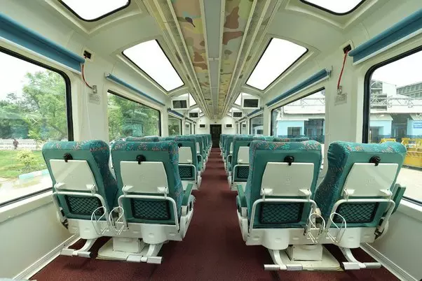 Interior view of the KTM Shuttle train showing comfortable seating arrangements.