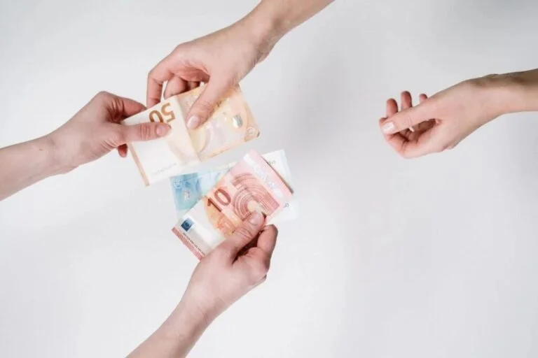 Person Holding 10 and 50 Banknotes