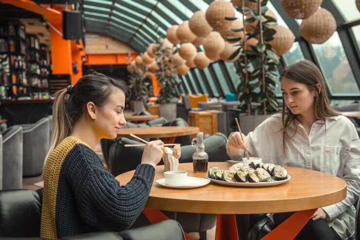 A cozy café in Singapore with patrons enjoying their drinks and food.