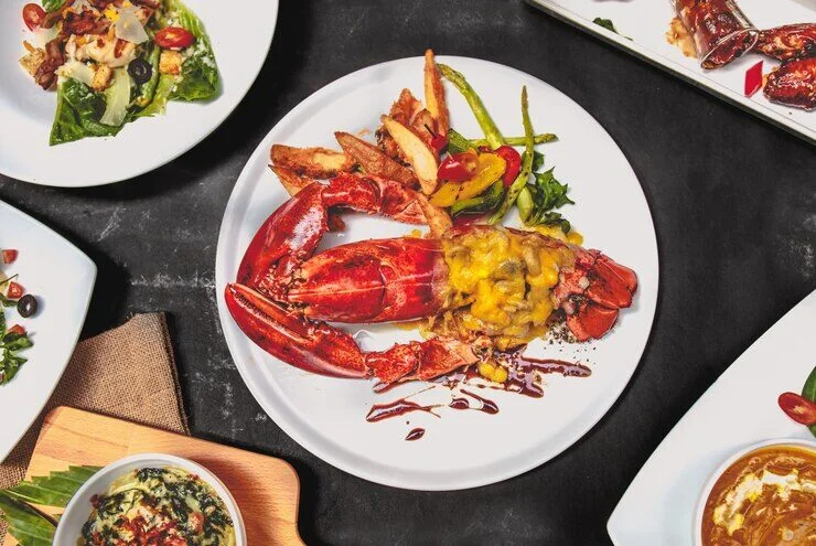 A plate of chili crab linguine garnished with fresh herbs